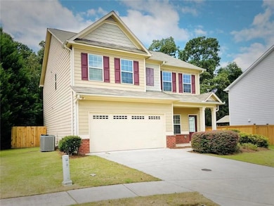 Craftsman-style home with concrete driveway, a garage, and brick siding