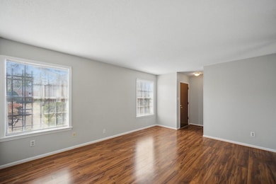 Empty room featuring wood finished floors and baseboards