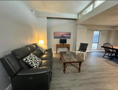 Living area featuring visible vents, baseboards, 
