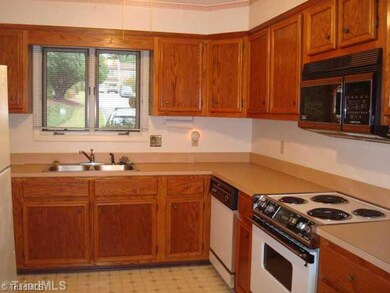 Kitchen. Kitchen features a window over the kitchen sink with a view of the nicely landscaped common area, and lots of storage.