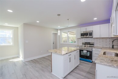 Kitchen with a sink, stainless steel appliances, b