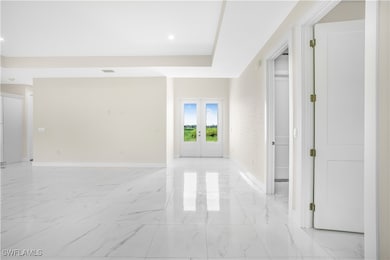 Unfurnished room with french doors