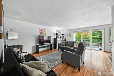 Enter into main living space.  It is bright and welcoming.  Sliding door leads to private balcony.