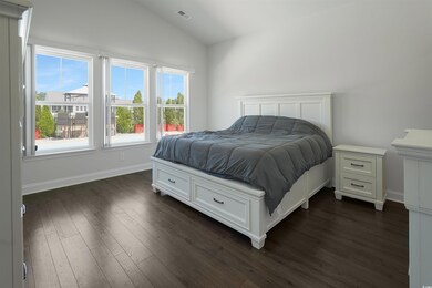 Overlooking the pool. Bedroom with dark wood-type 