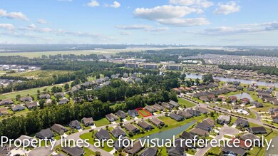 Birds eye view of property with a water view