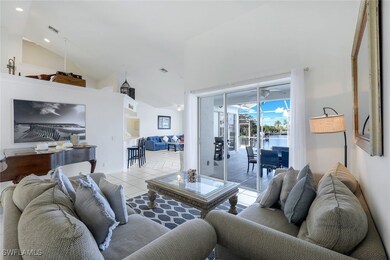 Living room featuring a water view, ceiling fan, l