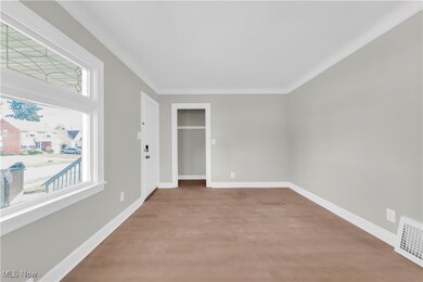 Empty room featuring baseboards and light wood finished floors