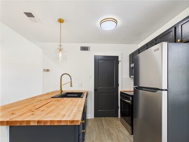 Kitchen with freestanding refrigerator, wooden cou