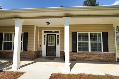 Property entrance featuring stone siding and a por