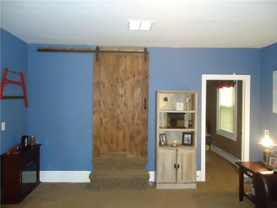 Trendy barn door ! Covers stairs and ensures priva