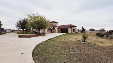 Mediterranean / spanish-style house featuring a ga