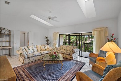 Tiled living room featuring ceiling fan, high vaul