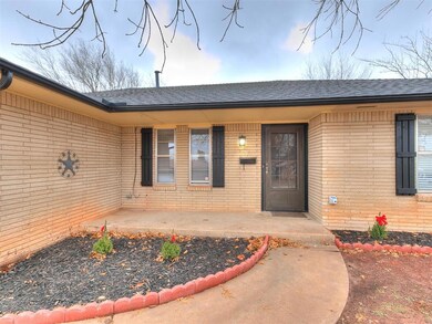 View of exterior entry with brick siding and roof 