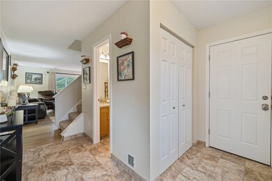 Neutral and upscale - coat closet and door leading to garage.