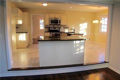 View into kitchen from family room.  Bar stools ca