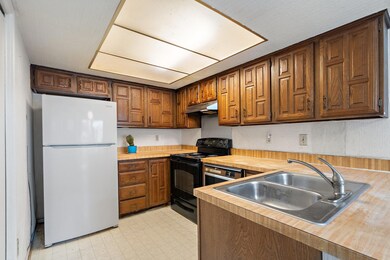 Kitchen featuring black electric range, light coun