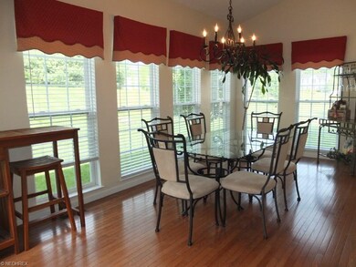 Morning room has hardwood flooring and vaulted cei