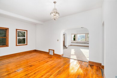 Spare room featuring wood-type flooring and a nota