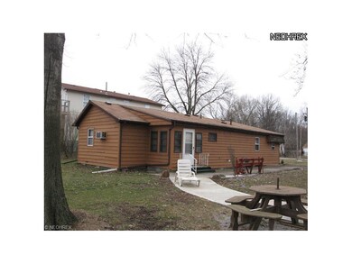 SIDE VIEW WITH ENTRANCE INTO ENCLOSED PORCH