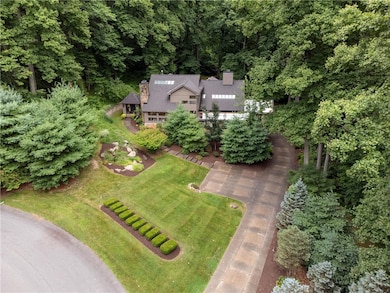 Nestled on a 1.39-acre wooded lot