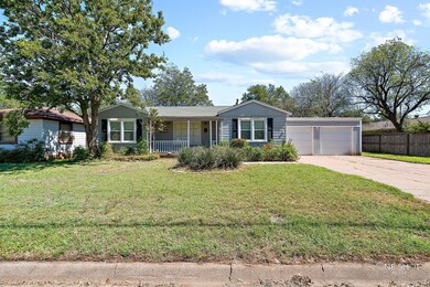 Ranch-style home with a porch, a garage, and a fro