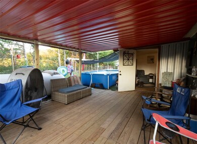 Side porch and entry to mud room. Pool in backyard