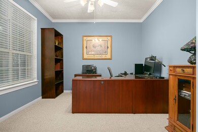Handsome study with crown molding and French doors for added privacy.