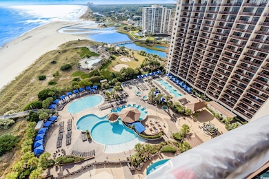 Aerial view of a pool area and a nearby body of water