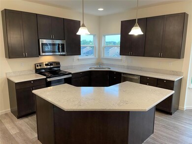KITCHEN WITH BREAKFAST BAR, QUARTZ COUNTERS AND ST