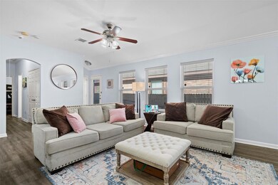 Living room with ceiling fan and dark wood-type fl