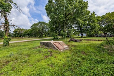 View of storm shelter featuring a yard