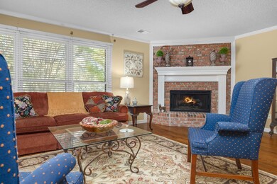 Living room featuring ornamental molding, hardwood