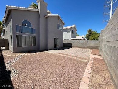 Back of property with a fenced backyard, a tile ro