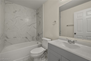 Bathroom featuring vanity, toilet, shower / bath c