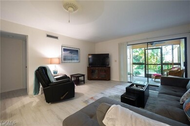 Living area with wood finished floors and ceiling fan