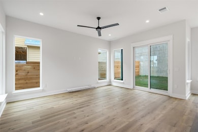 Empty room with wood finished floors, a ceiling f