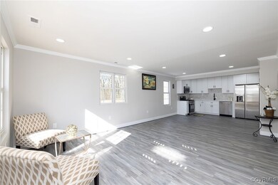Living room with crown molding and light wood-type