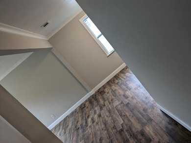 Details featuring ornamental molding, a skylight, and hardwood / wood-style flooring