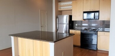 Kitchen with granite counters, SS refrigerator and
