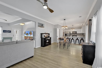 Living area with visible vents, ornamental molding