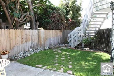 Spacious rear yard with staircase leading to roof 
