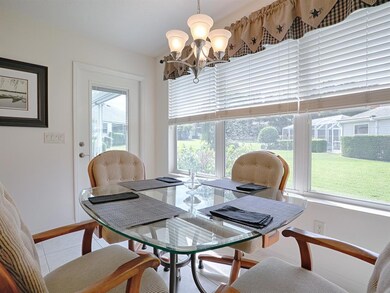 Breakfast Nook with window treatments and a french door to the wrap-around lanai!