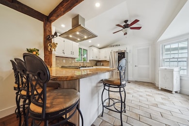 Updated kitchen with gas range, island and access to laundry room and 2-car garage