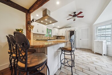 Updated kitchen with gas range, island and access to laundry room and 2-car garage