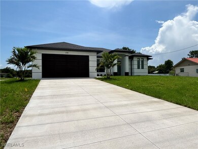 Prairie-style home featuring concrete driveway, an