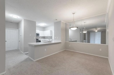 Kitchen featuring ceiling fan, kitchen peninsula, 