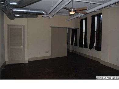 exposed duct work and stained concrete floors give
