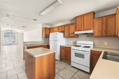Kitchen with white appliances, under cabinet range