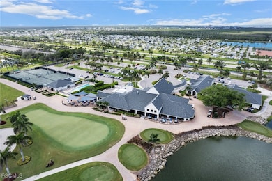 Aerial view of property and surrounding area featuring a large body of water and a golf club