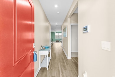 Hallway with light hardwood / wood-style flooring